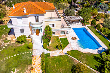 Aerial drone view showcasing pool area and villa architecture